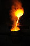Foundry - molten metal poured from ladle for casting