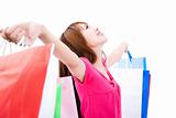 young woman holding shopping bag and looking up