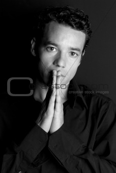 Handsome man portrait hands on mouth black and white