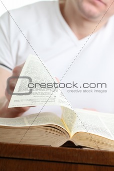 Man turning the page of the Bible