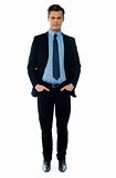 Young businessperson posing with hands in pocket