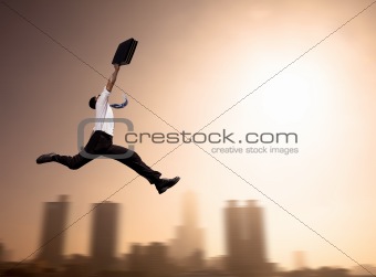 excited Businessman running with cityscape background at morning