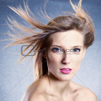 Fashion portrait of beautiful woman with streaming hair