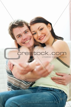 Portrait of happy young couple with porcelain hearts