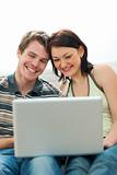 Happy young couple surfing internet