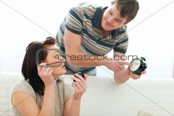 Guy trying to hurry up girlfriend applying make-up too long