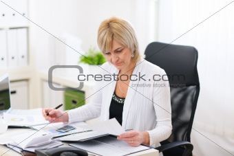 Mature business woman working at office