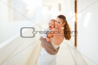 Smiling mother with baby playing outdoor