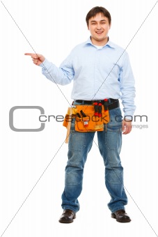 Full length portrait of construction worker pointing on side