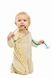 Curious kid playing with stethoscope on white background