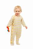 Smiling kid standing with rattle on white background