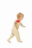 Cheerful baby running with rattle on white background