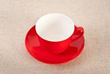 Empty red coffee cup on canvas background