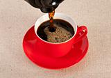 Red coffee cup filled with black expresso