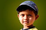 Photo of handsome indian boy with a cap smiling
