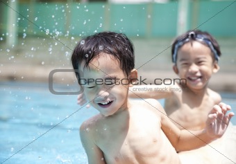 happy kids in swimming pool
