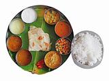 South indian plate meals on banana leaf on white