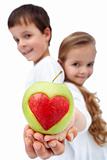 Happy healthy kids holding apple