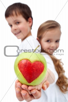 Happy healthy kids holding apple