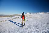 woman hiking to snow mountains