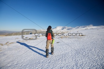 woman hiking to snow mountains