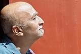 profile balding senior Indian male hook nose