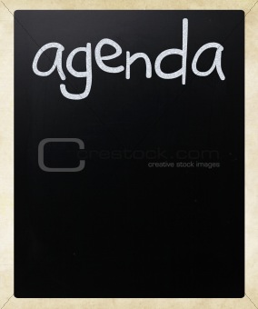 "AGENDA" handwritten with white chalk on a blackboard
