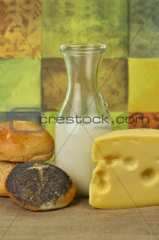 milk bottle , cheese and fresh rolls