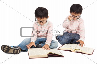children reading  book on the floor and isolated on white