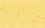 Background of yellow Swiss cheese with holes