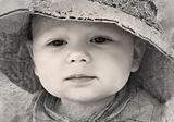 Black and white retro photo of adorable thoughtful little boy closeup