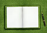 Blank book on grass