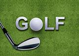 Golf ball and putter on green grass 