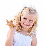Adorable Little Blonde Girl with Starfish Isolated on a White Background.