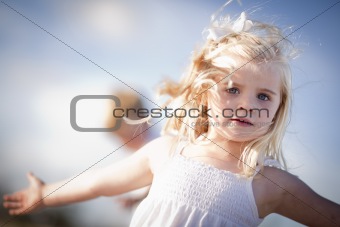 Adorable Blue Eyed Girl Playing Outside with Her Family.