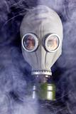 Man is in Gas Mask with Smoke around and Fire reflection