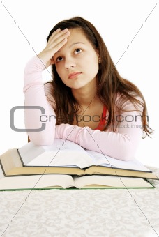 Teenage girl dreaming over books