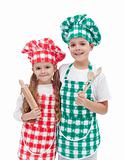 Happy kid chefs with wooden cooking utensils