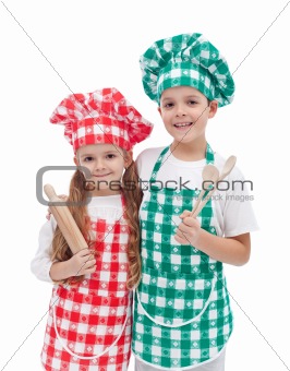 Happy kid chefs with wooden cooking utensils