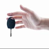 Woman's hand giving key from car