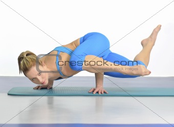 Woman in yoga pose standing on her hands