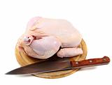 Uncooked chicken on a cutting board.