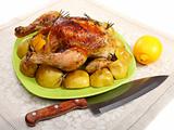 Chicken stuffed with lemons, apples and rosemary.
