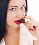close up of woman's lips biting a bar of chocolate 