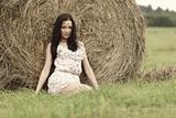 girl next to haystack