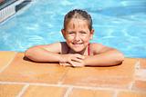Happy girl smiling at swimming pool