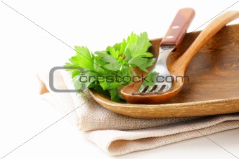wooden plate and cutlery on a white background