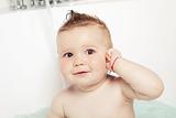 Cute baby showing "where the ear is" and smiling while taking a bath 