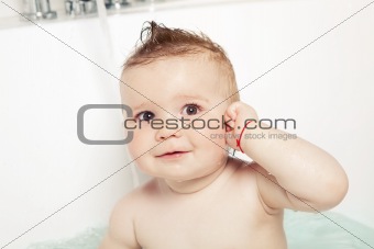 Cute baby showing "where the ear is" and smiling while taking a bath 
