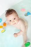Cute baby looking up while taking a bath 